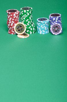 A stack of chips on a green playing a gambling table in a casino
