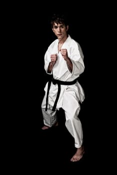 Karate male fighter young high contrast on black background