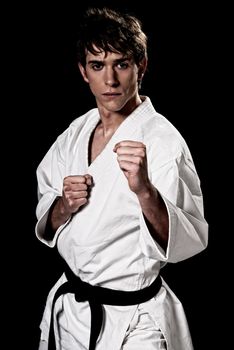 Karate male fighter young high contrast on black background