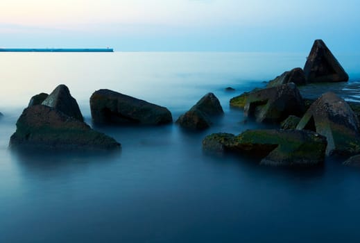 Stones in calm sea water, early morning light