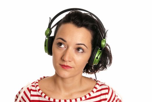 Young woman listening music with headphones isolated on white background