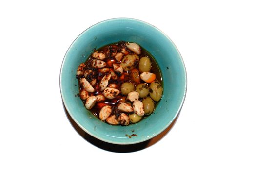 A bowl of marinated olives and garlic.