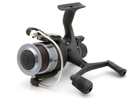 Black graphite fishing reel, nobranded, isolated on a white background