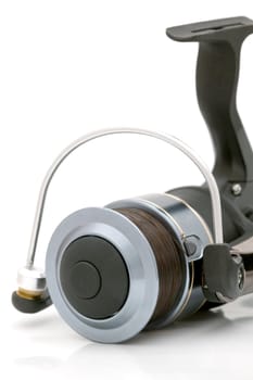 The front of a black graphite fishing reel