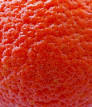 Strict closeup of skin of an orange, for background