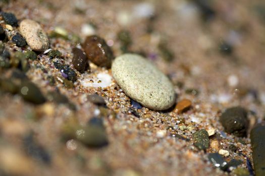 White SPA stone on the beach sand