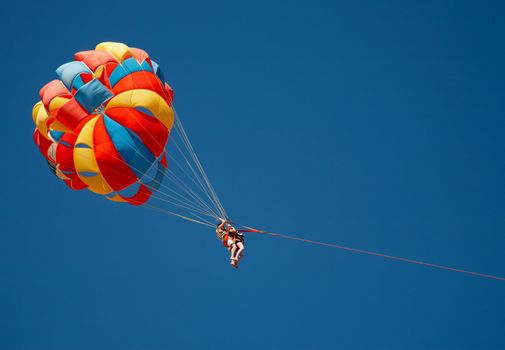 Colorful parachute in the blue sky