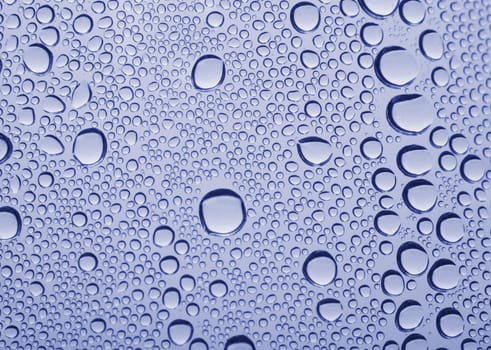 Bright water drops on glass texture