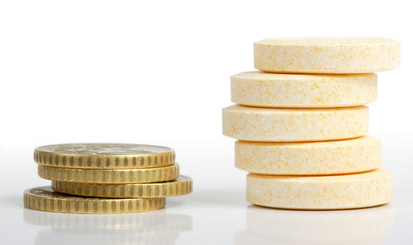 Heaps of pills and coins close-up