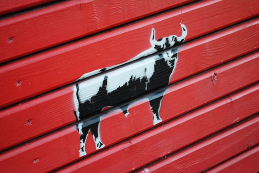 A stencil graffiti piece of a bull.