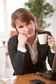 Business woman taking a break from work with a coffee
