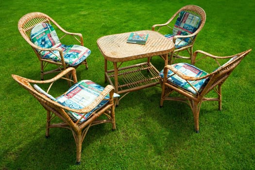 Table and chairs on a green grass