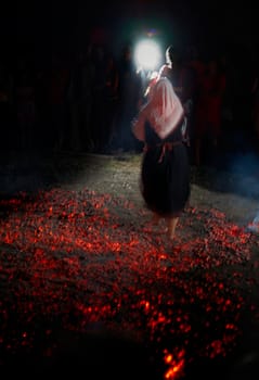 Bulgarian tradition Nestinari firedancer, a woman dancing on live coals