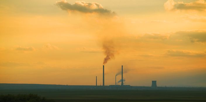 Smoke from a factory at sunset