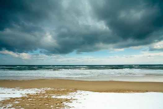 Black sea beach in the winter, with snow on the sand