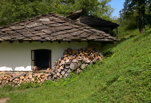 Old traditional house with stone-tiled roof