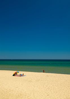 A couple taking sunbath on a beach at the Black sea coast, Bulgaria