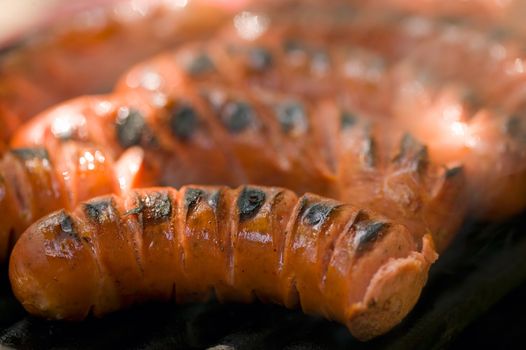 Pieces of sausage on a grill, barbecue food photo