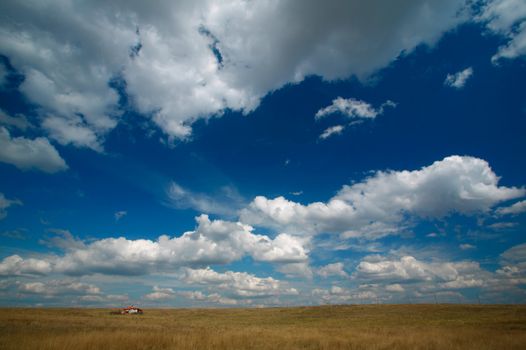 Landscape with house, blue sky and clouds