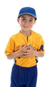 Young boy wearing a baseball or T-ball style sport outfit and blue cap.  White background.