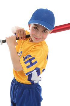 A smiling boy with a baseball or t-ball bat and uniform.  White background.