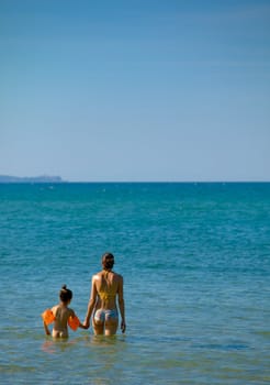 Mother and daughter in the sea water