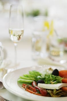 Italian salad with mozzarella, cucumbers, red peppers and black olives