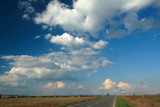 Rural landscape with road and cloudy sky