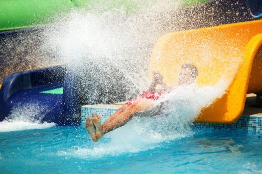 Man, sliding on water slide