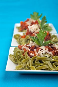 tagliatelle with sauce bolognaise in white plates