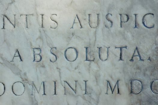 latin phrase on white marble background