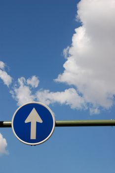 Way to heaven - blue road sign with white arrow on sky background