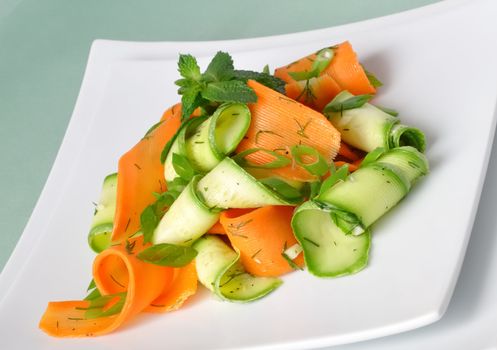 Zucchini salad with carrots and garlic marinade with herbs