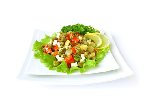 A salad of red peppers with goat cheese, capers, fresh herbs in the marinade