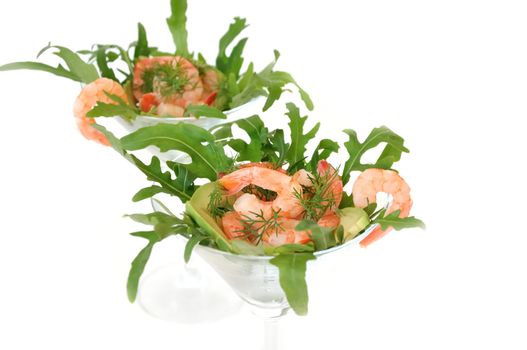 Shrimp in a glass with avocado and arugula close