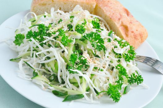 Summer Salad Fresh cabbage and cucumber salad with greens and sesame