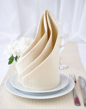  Coordinated decorative napkin on a plate with cutlery