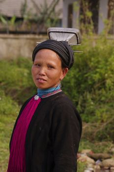 Woman wearing the headdress of the black Dao ethnic « tien ».She is dressed all in black. Her headdress is made of a braid cone topped with a rectangular mattress elements aluminium.Coiffe typical black Dao of north Vietnam