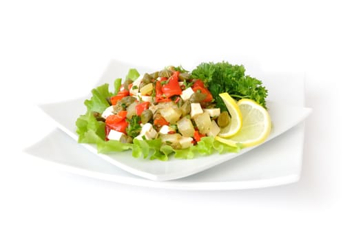 A salad of red peppers with goat cheese, capers, fresh herbs in the marinade