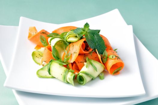 Zucchini salad with carrots and garlic marinade with herbs