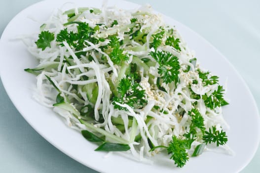 Summer Salad Fresh cabbage and cucumber salad with greens and sesame