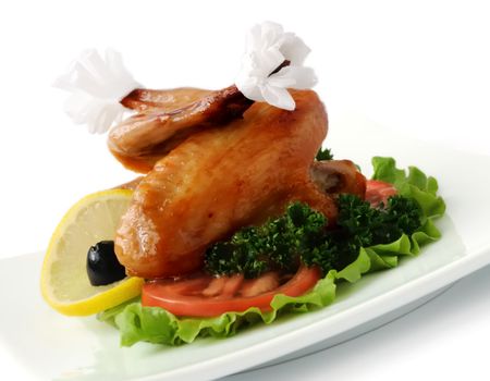 Fried chicken wings with tomato on white background