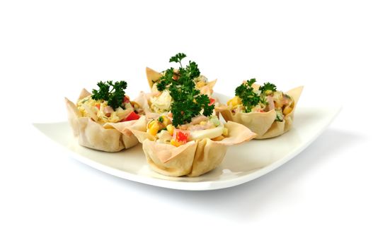 Baskets, stuffed with a salad of corn, Chinese cabbage, egg, ham, peppers and mayonnaise