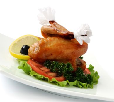 Fried chicken wings with tomato on white background