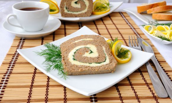 Slices of liver pate with butter and coffee for breakfast