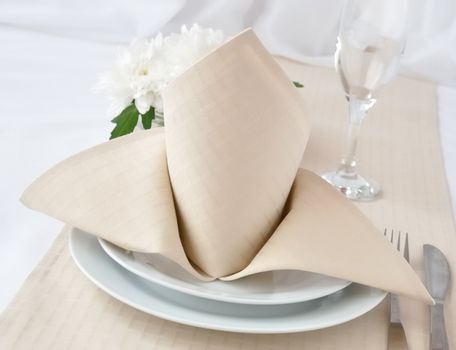  Coordinated decorative napkin on a plate with cutlery 