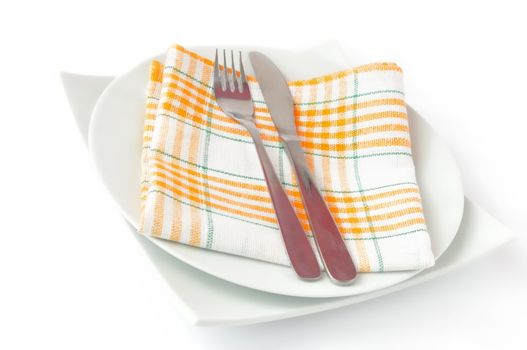 Napkin, folded on a plate with knife and fork c isolated