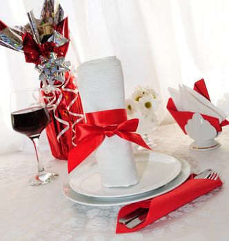 Table setting for a holiday napkin, flowers, wine