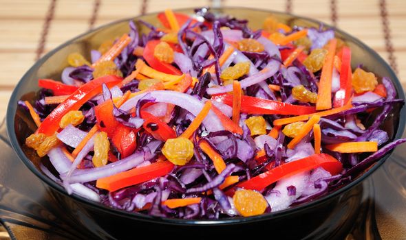 Salad of blue cabbage with carrots, peppers and raisins