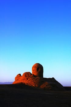 Landmark of an ancient castle ruins in the desert at sunrise